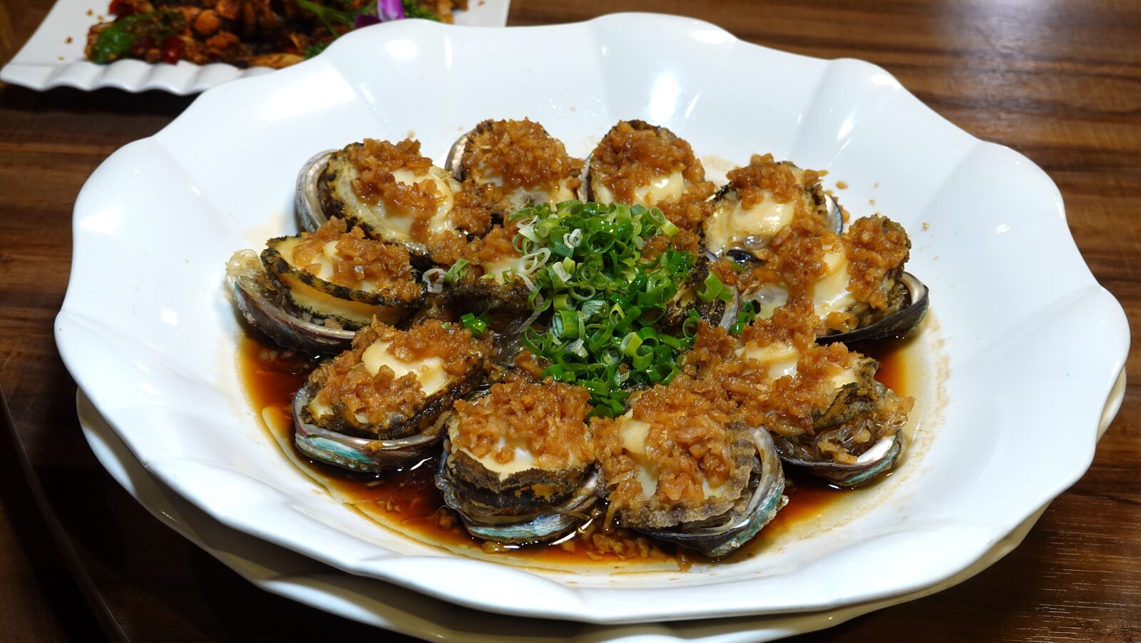 다진 마늘을 듬뿍 올린 마늘 활전복찜 열 개 한 접시