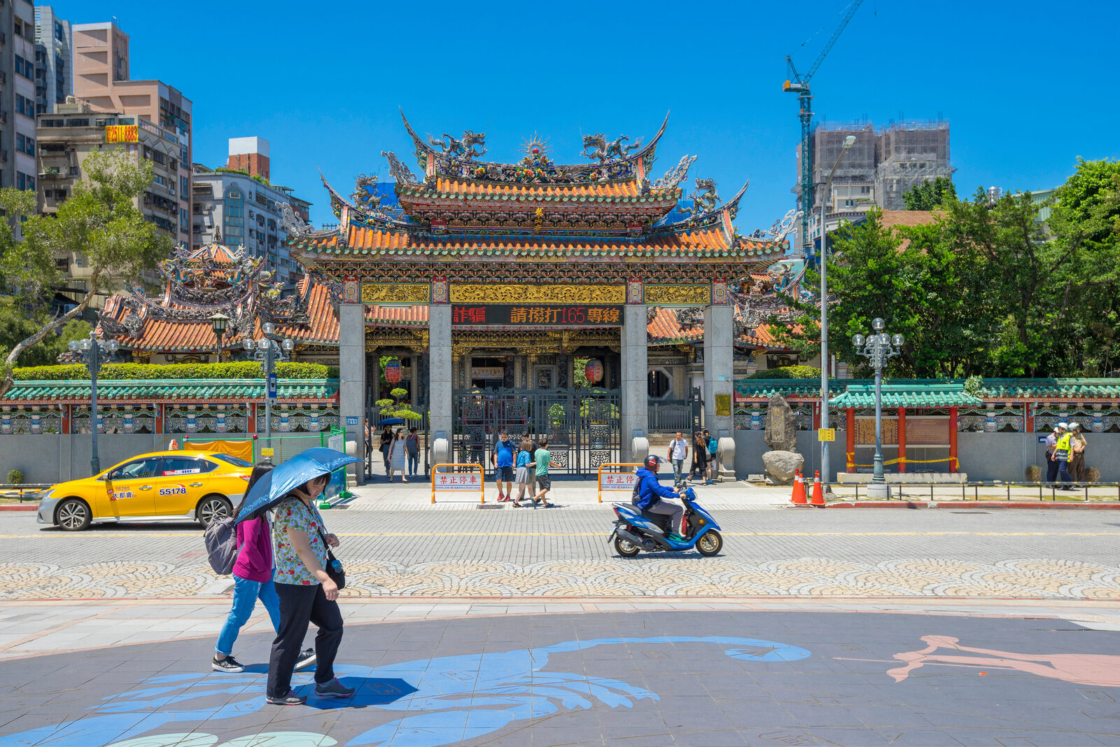台北艋舺龍山寺入口,屋頂剪黏、石碑與廣州街街景同時入鏡