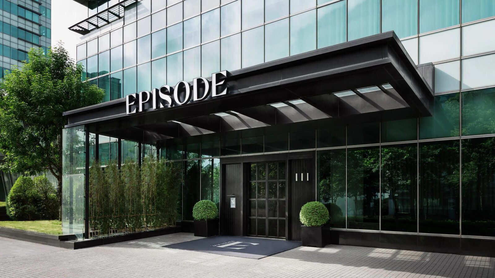 The EPISODE lettering on the entrance canopy and the glass facade of EPISODE Hsinchu
