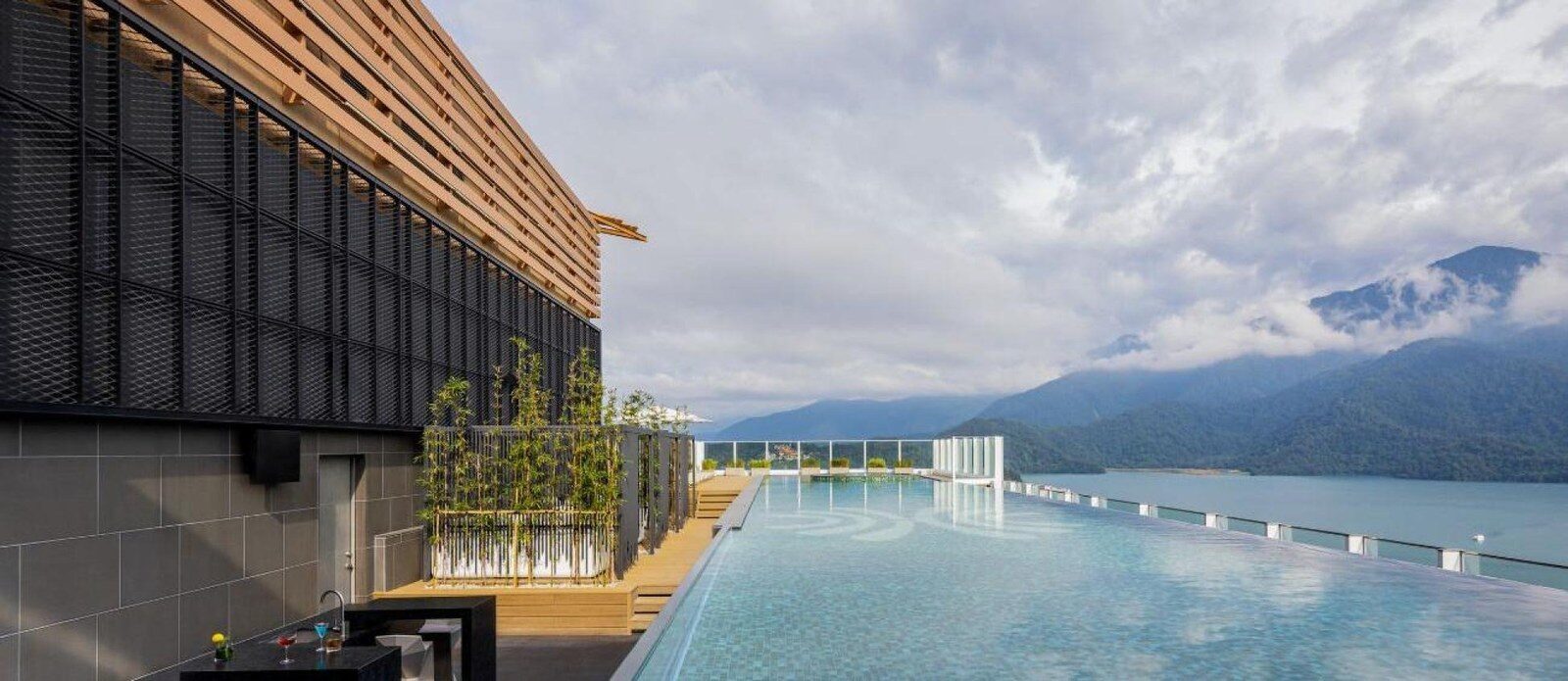 The 12th-floor outdoor infinity pool at Grand Hilai Sun Moon Lake with the lake and mountains in the distance