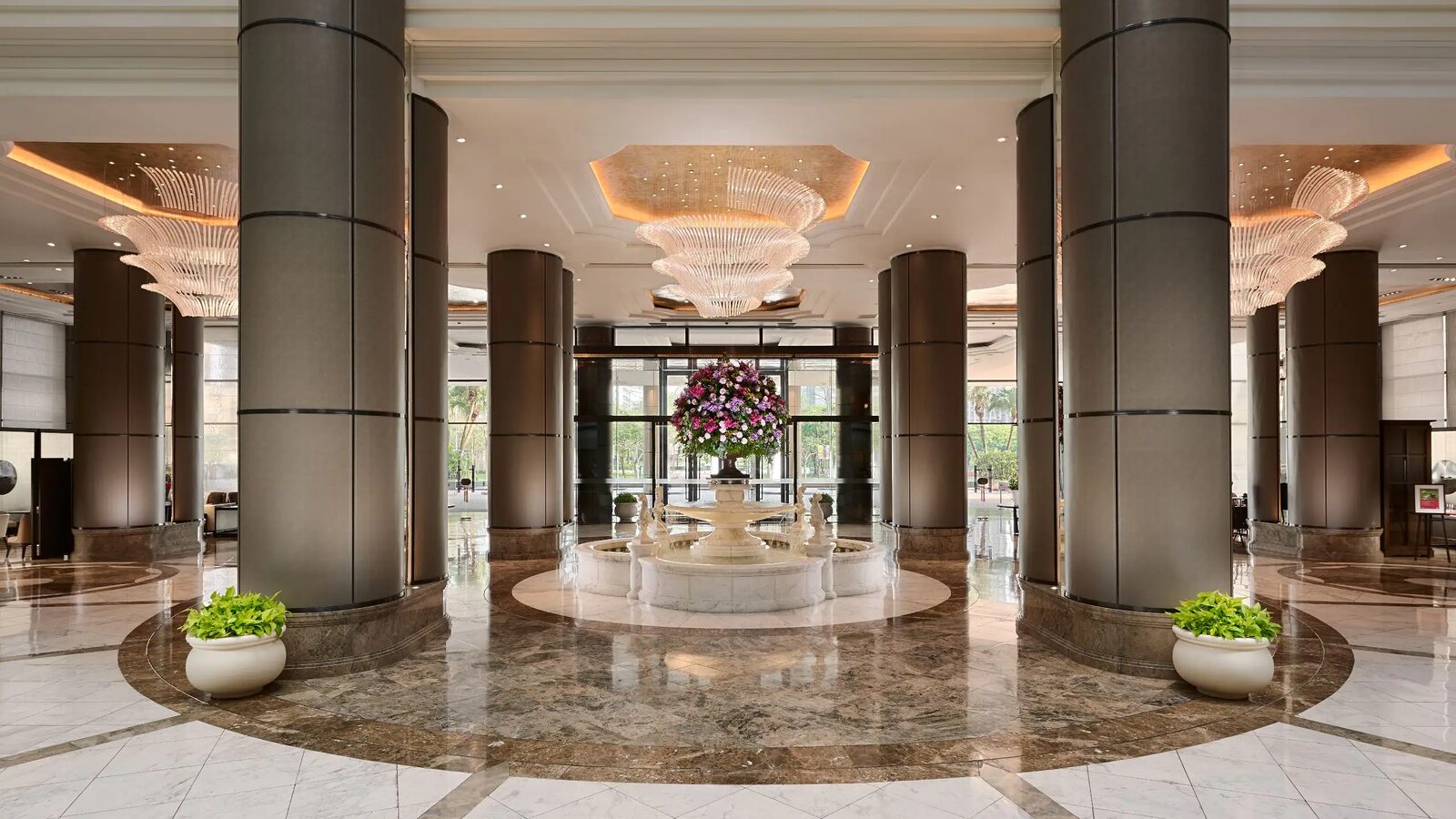 Marble columns, crystal chandeliers and the central fountain in the lobby of Grand Hyatt Taipei