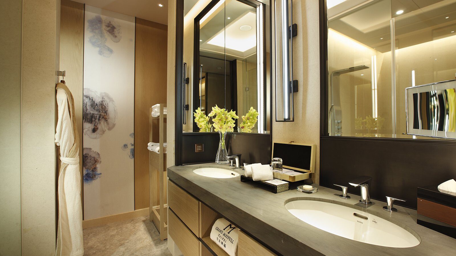 Double washbasins and bathrobes in a bathroom at Grand Mayfull Hotel Taipei