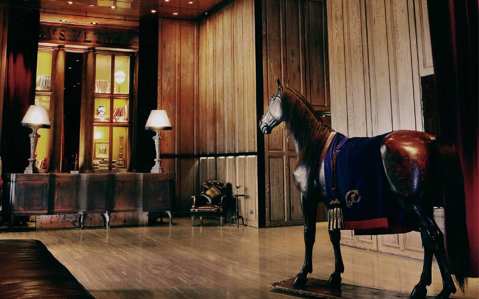 The life-size horse statue Lady and wooden bookcases in the 1st-floor lobby of Palais de Chine Hotel