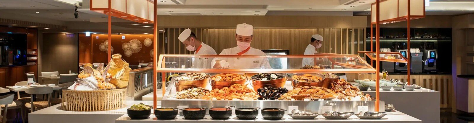 Buffet counters and chefs in front of the open kitchen at Café at Far Eastern