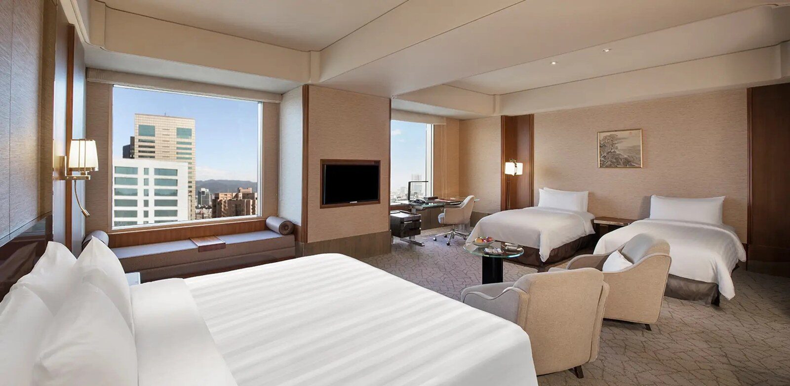 One large bed and two single beds in a family room