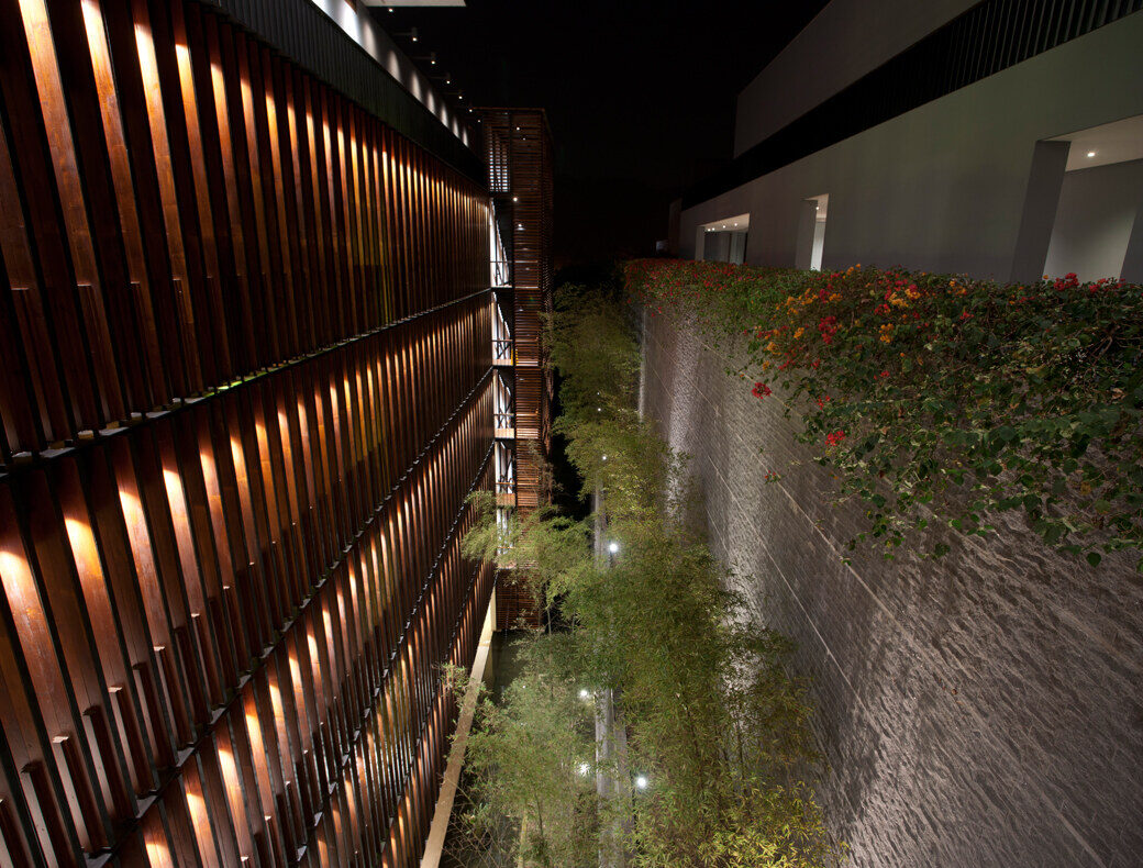 A long corridor with wooden louvers and stone walls at The Lalu, Sun Moon Lake