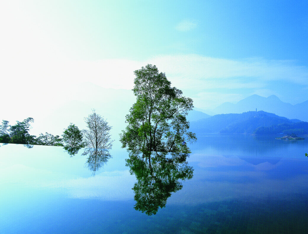The outdoor infinity pool at The Lalu, Sun Moon Lake, with the lake and mountains in the distance