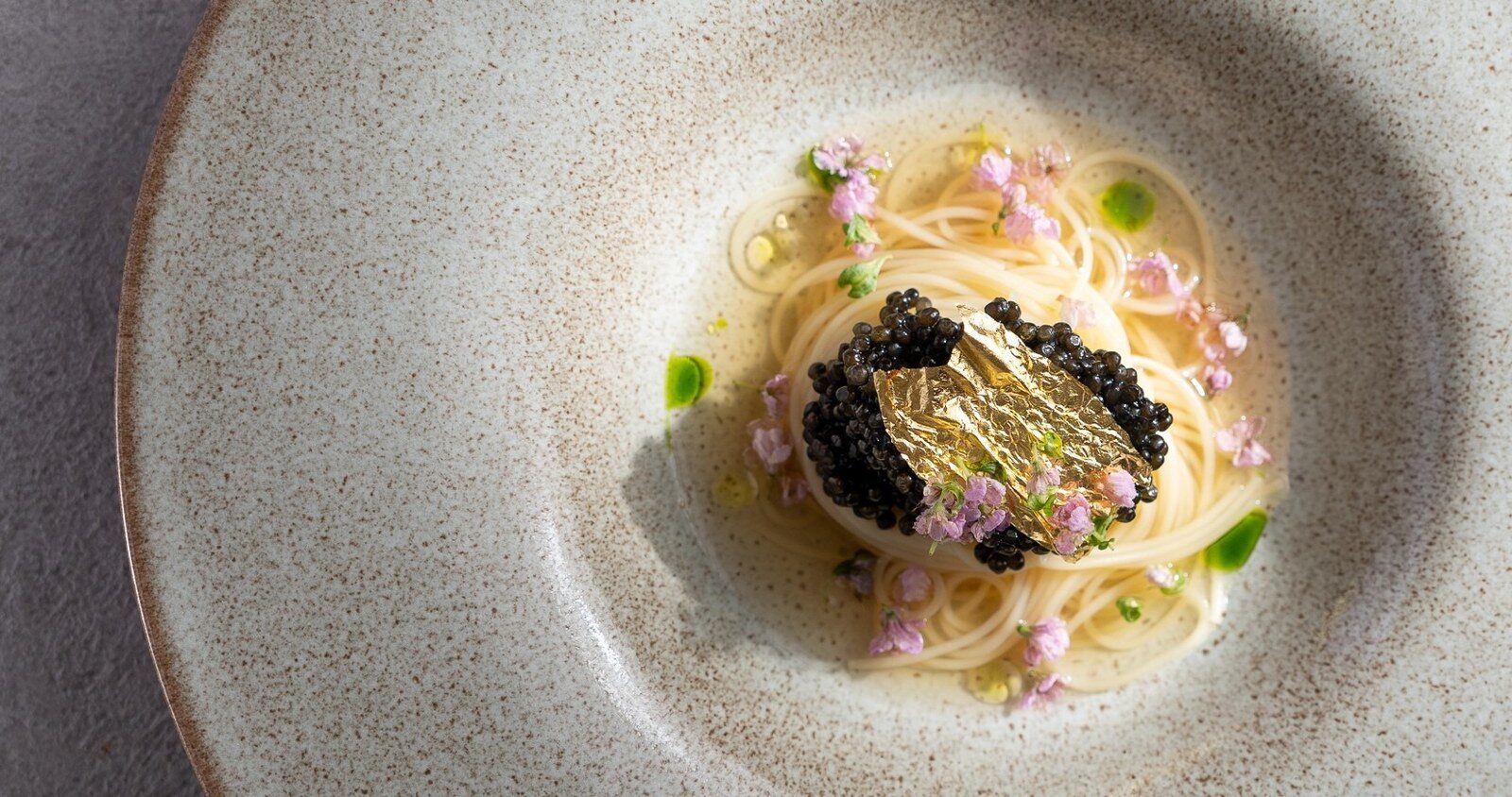 Fine pasta with caviar on a ceramic plate